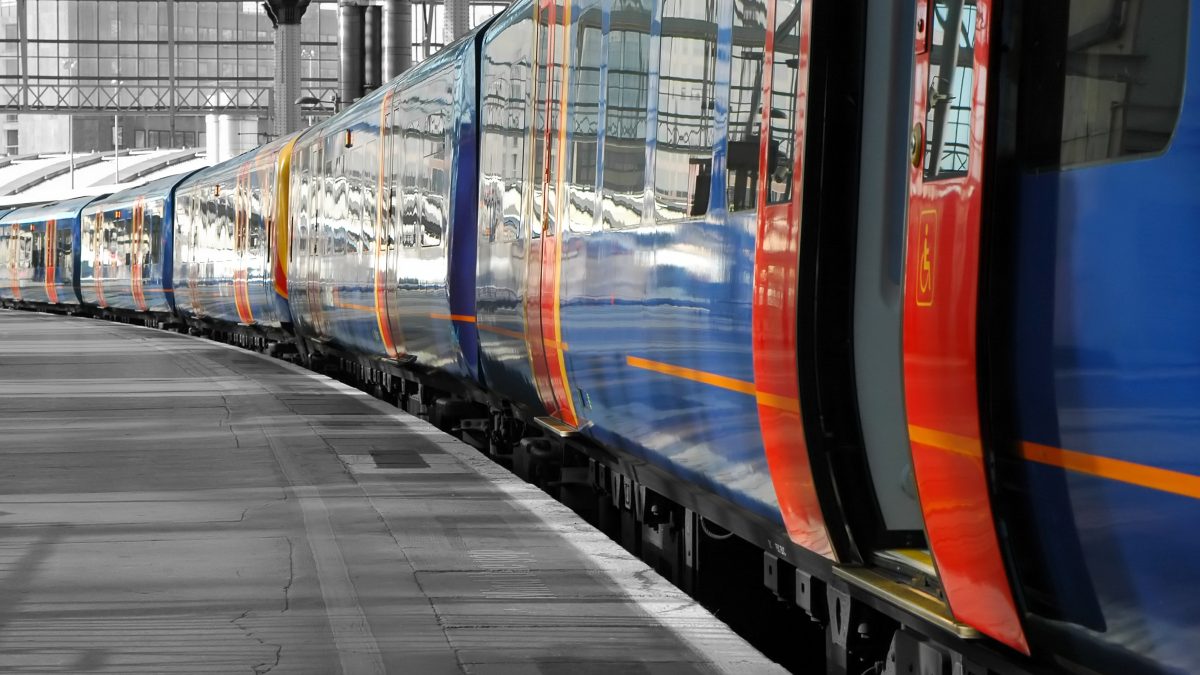 Train pulled up in station with open doors