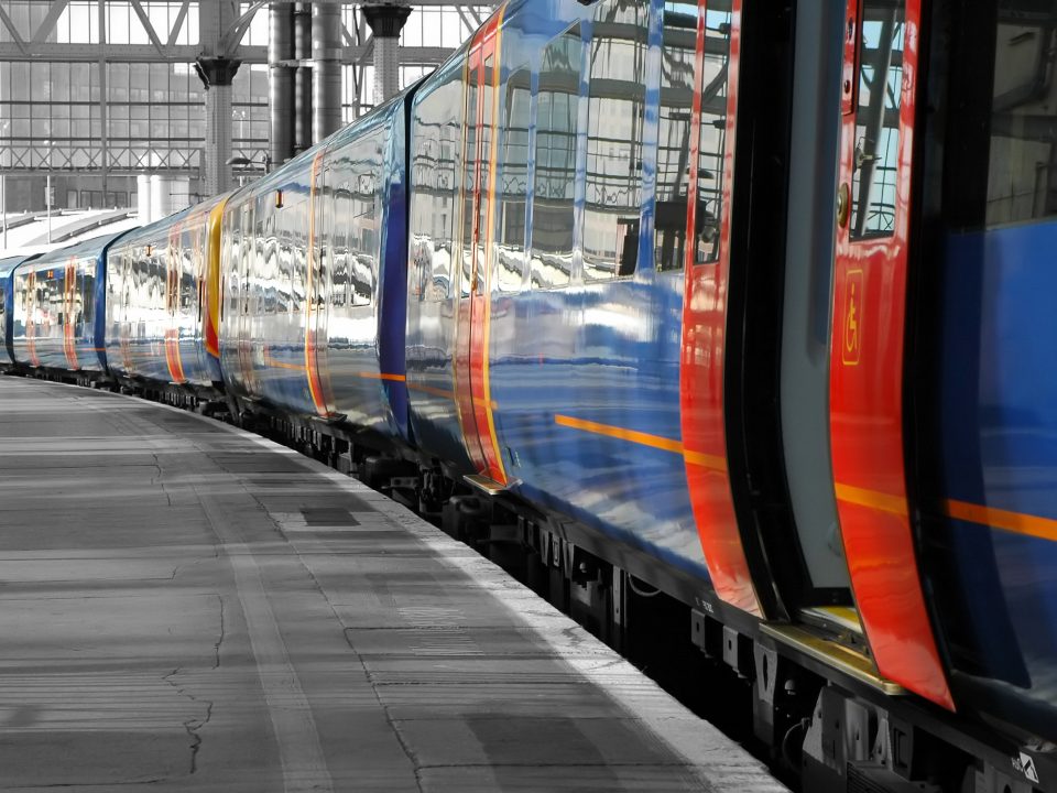 Train pulled up in station with open doors